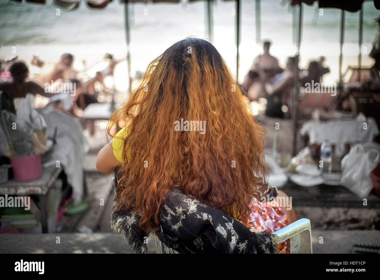 Frizzy Hair. Woman sporting a mass of ginger crinkly hair. Rear view, from behind. Stock Photo