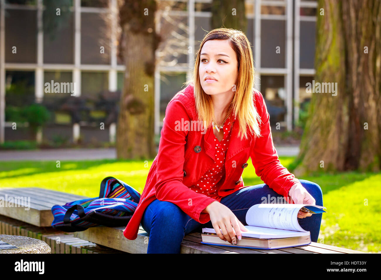 A young female college student study books outside of library. Stock Photo