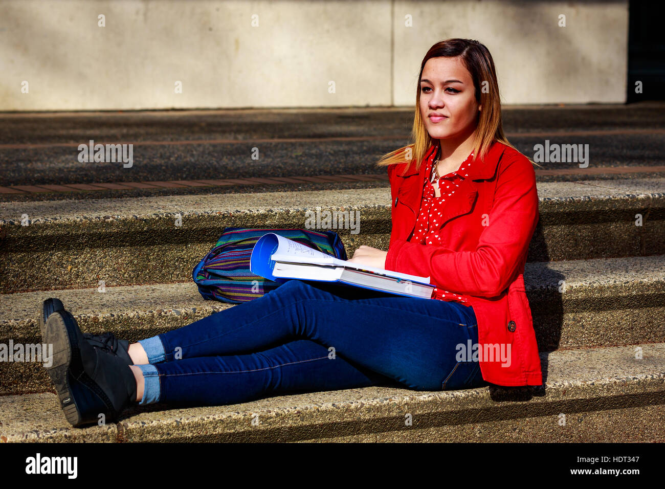 A young female college student study books outside of library Stock ...