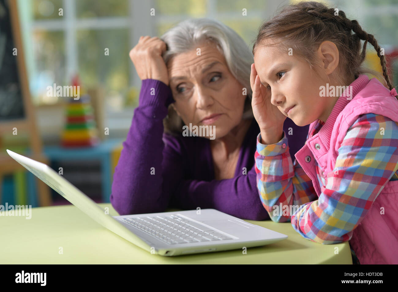 Grandmother and granddaughter with laptop Stock Photo - Alamy