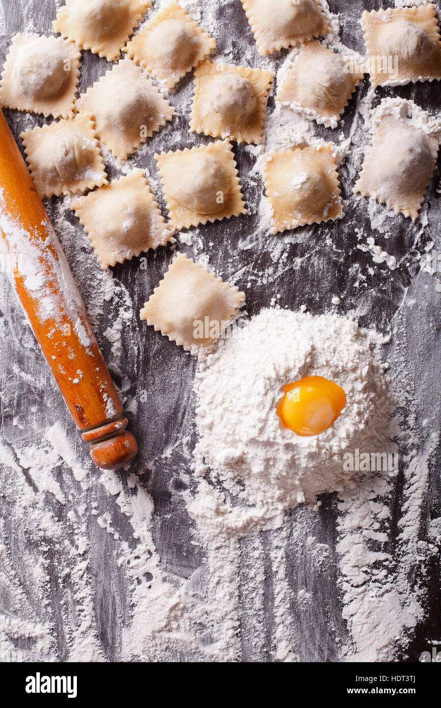 Italian ravioli with raw ingredients on the table. vertical view from above Stock Photo