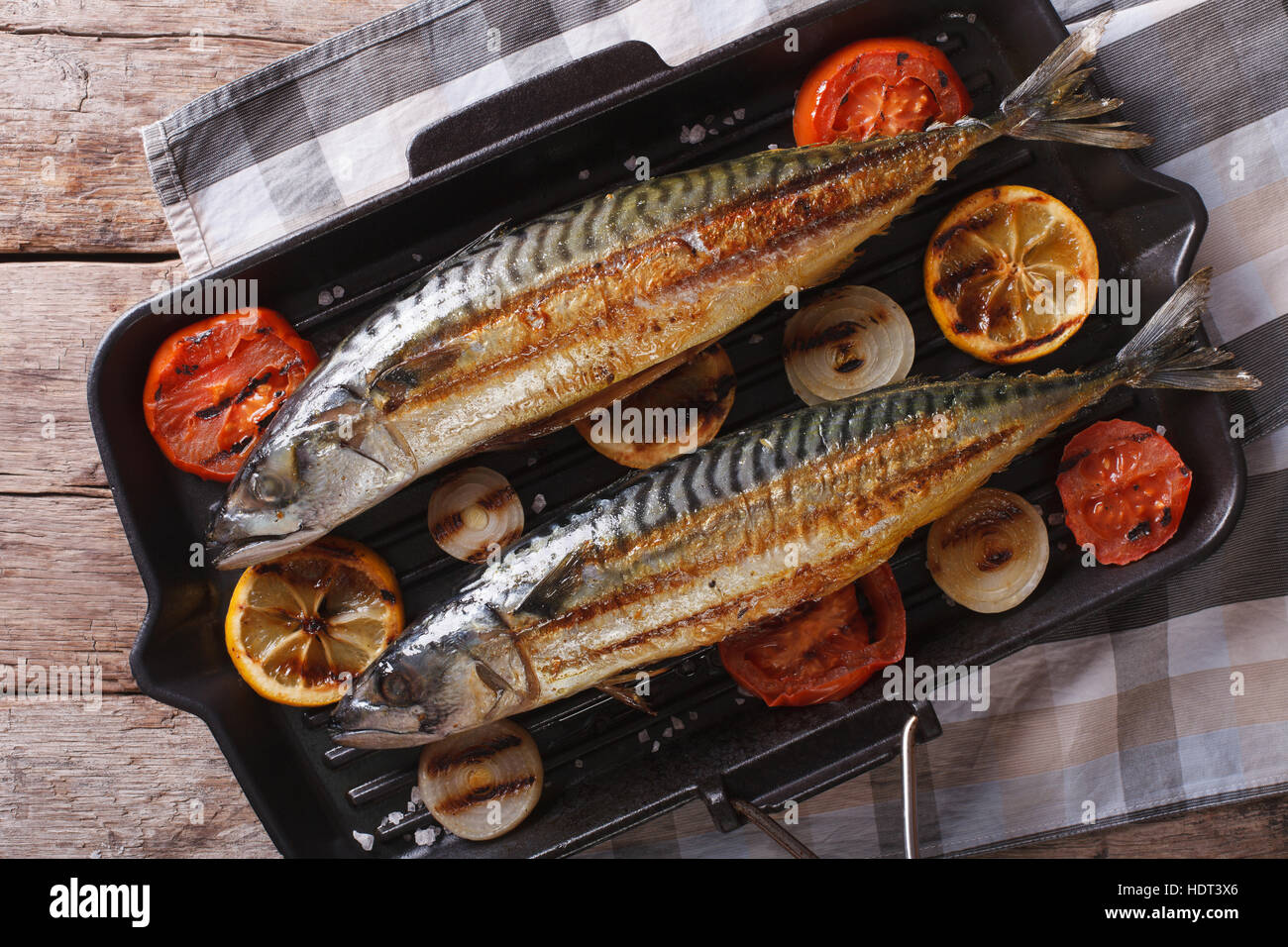grilled mackerel fish on a grill pan closeup. horizontal view from