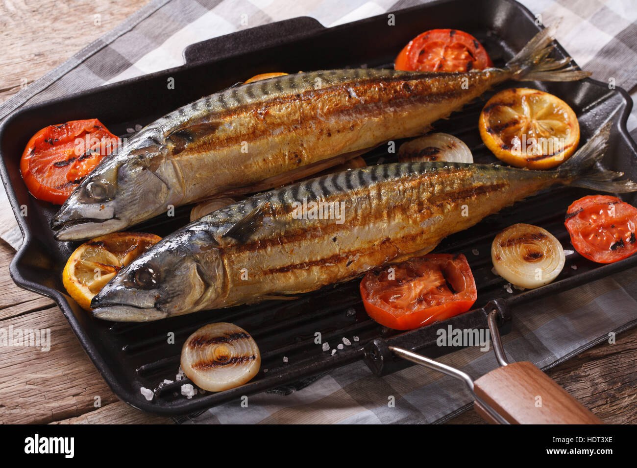 Grilled sea fish and vegetables in a pan grill closeup. horizontal Stock Photo