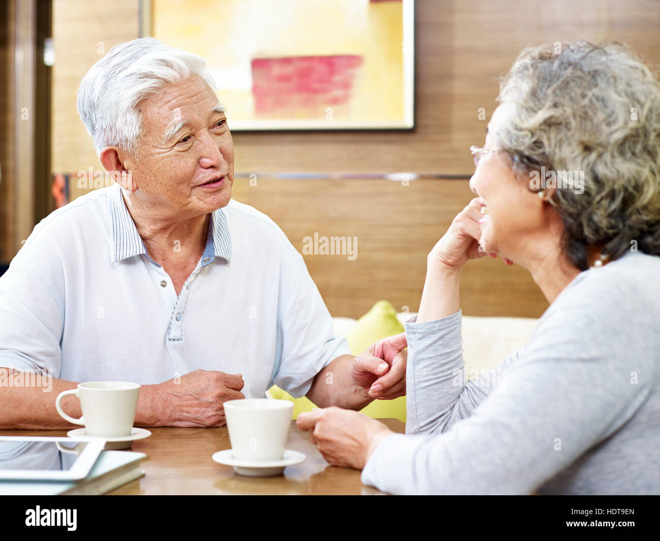 loving senior asian couple drinking coffee and chatting Stock Photo