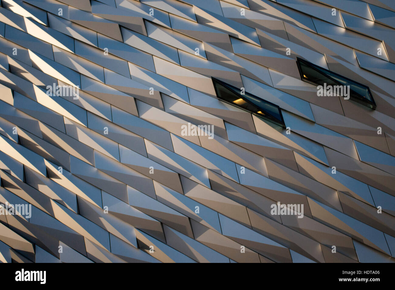 Titanic Belfast museum and Visitors Centre, Titanic Quarter, Belfast, Northern Ireland, UK. The building is clad in metal shards and when the light pl Stock Photo