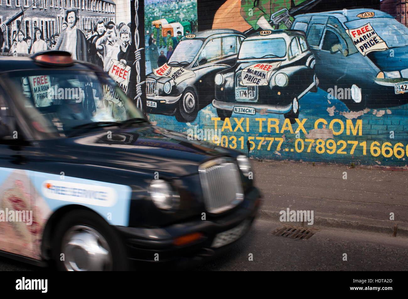 Belfast Black Taxi tours in front of one of the loyalist murals Falls road street, Belfast, Northern Ireland, UK. U.F.F. Mural, East Belfast 'For as l Stock Photo