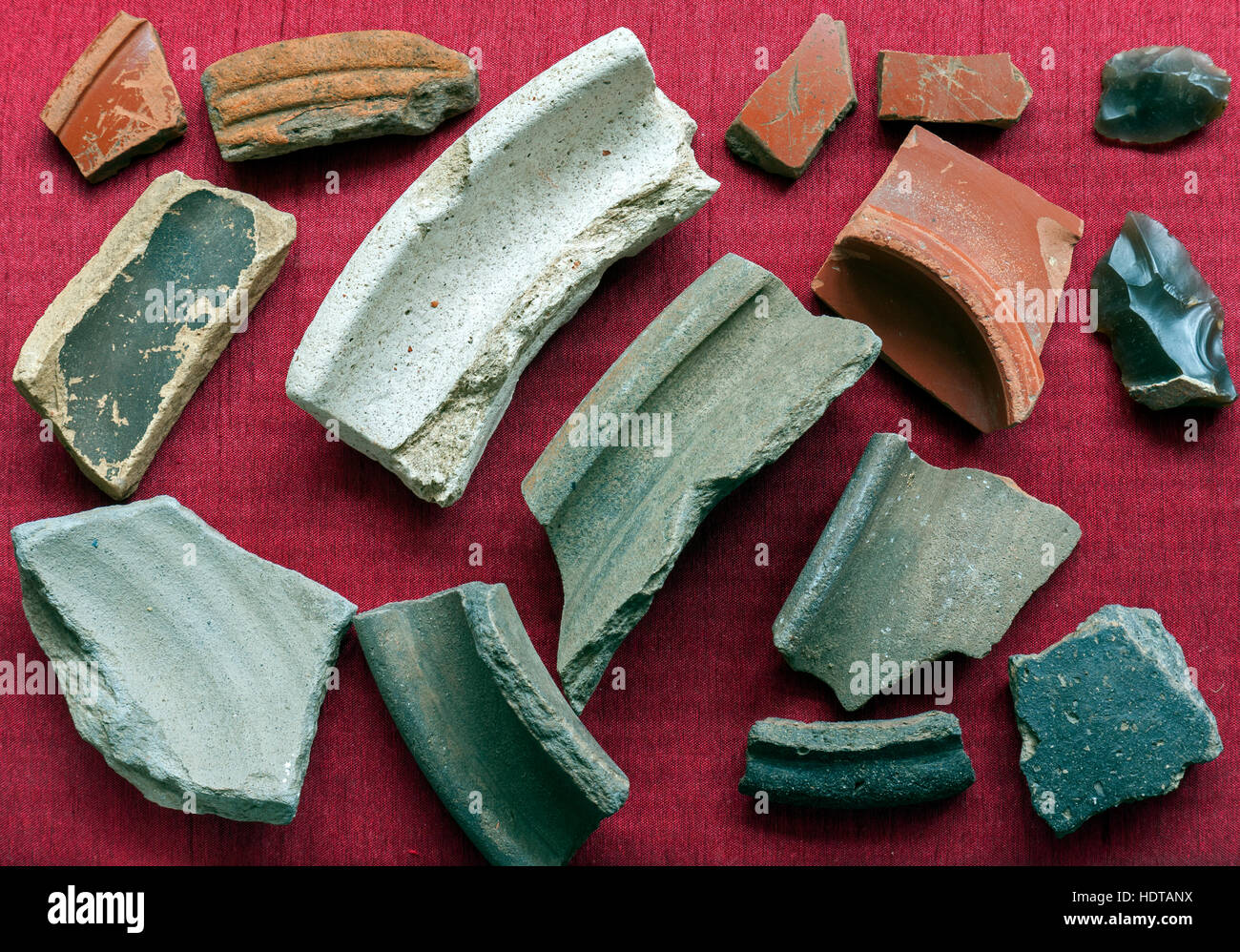 Roman pottery shards and flints found field walking. Stock Photo