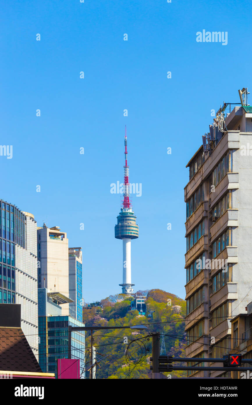 View from city center downtown to radio and tv tower, YTN or N Seoul Tower  atop Namsan mountain on a clear, blue sky day Stock Photo - Alamy