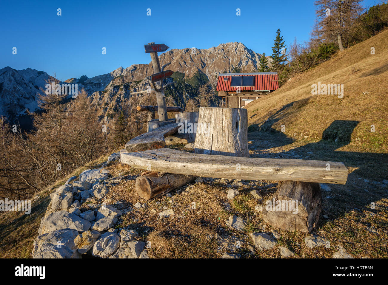 A bench in the mountains in the evening light Stock Photo