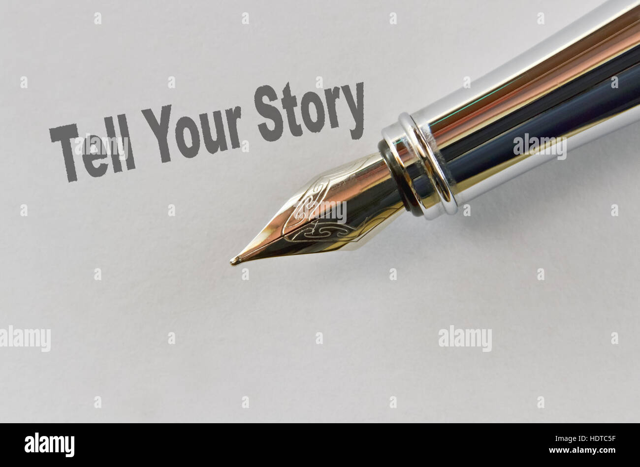 Closeup of the nib of a fountain pen and text Tell Your Story Stock Photo