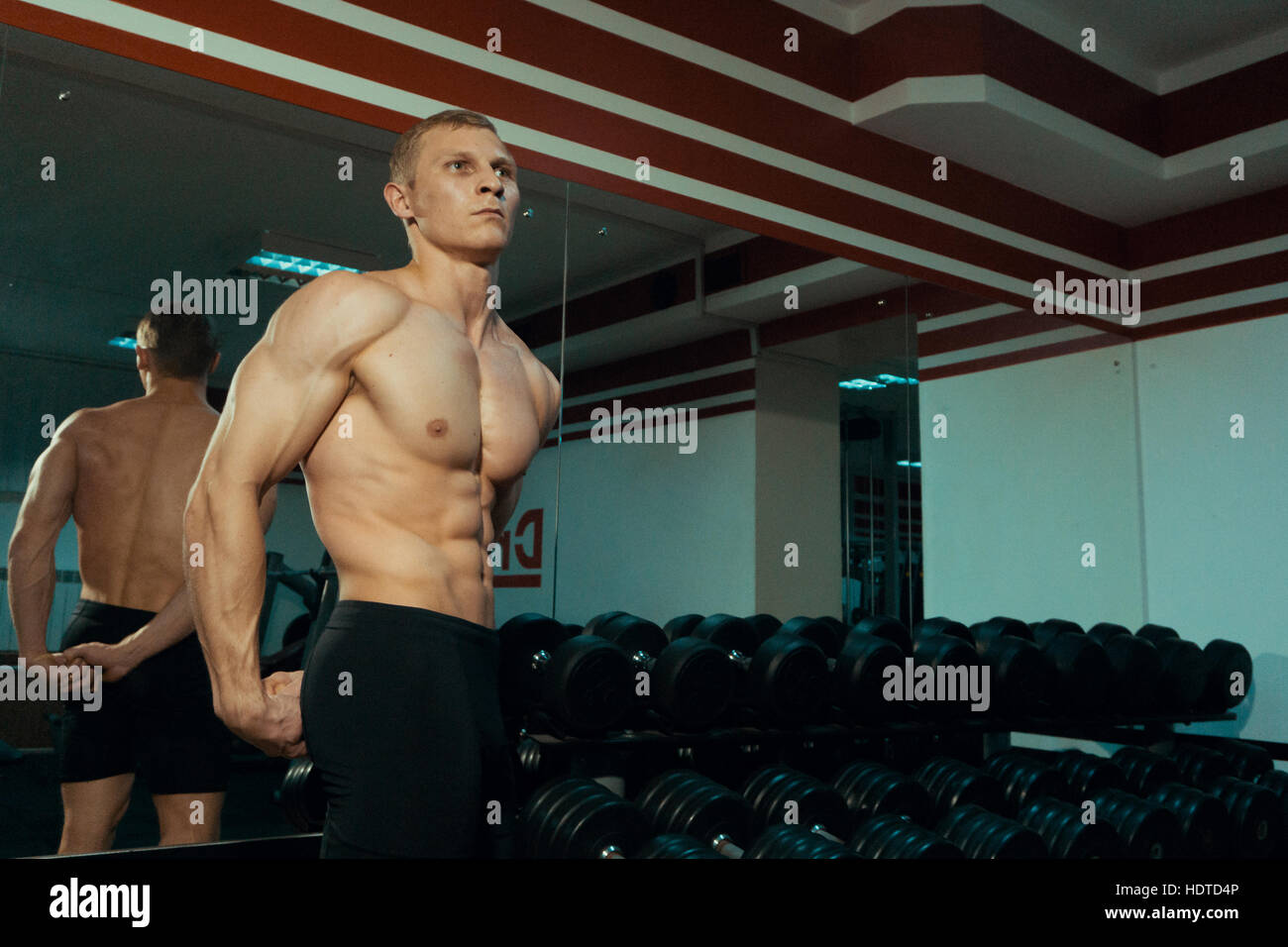 Beautiful bodybuilder near a dumbbell in the gym Stock Photo Alamy