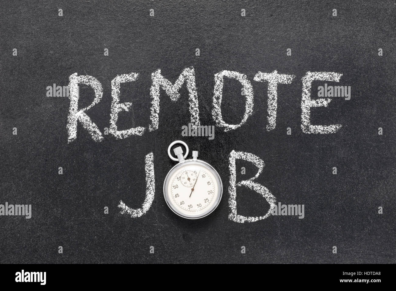 remote job phrase handwritten on chalkboard with vintage precise stopwatch used instead of O Stock Photo