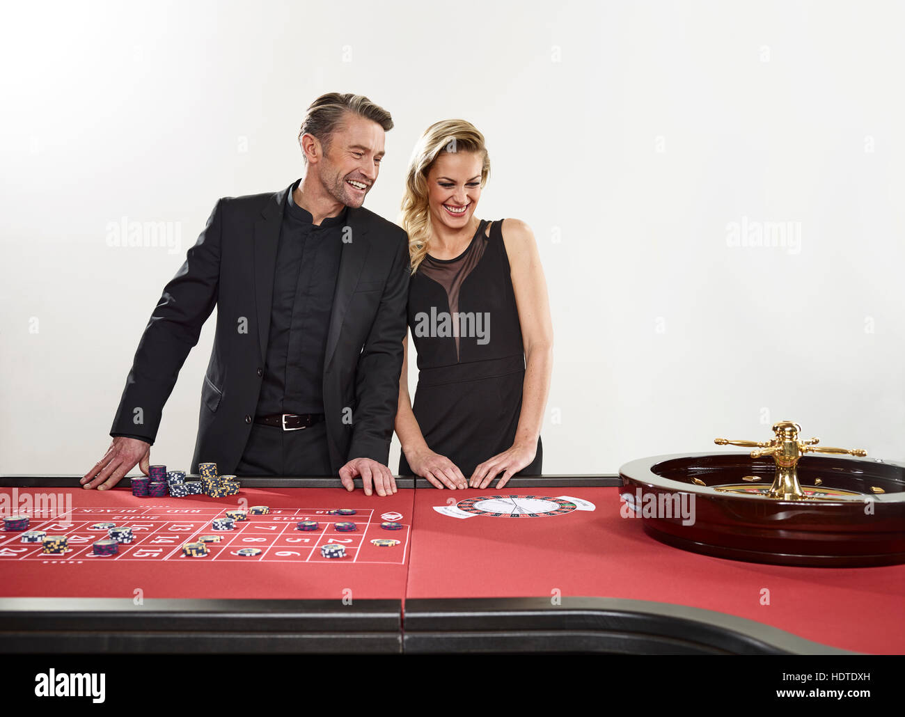 Couple playing roulette, casino, chips Stock Photo