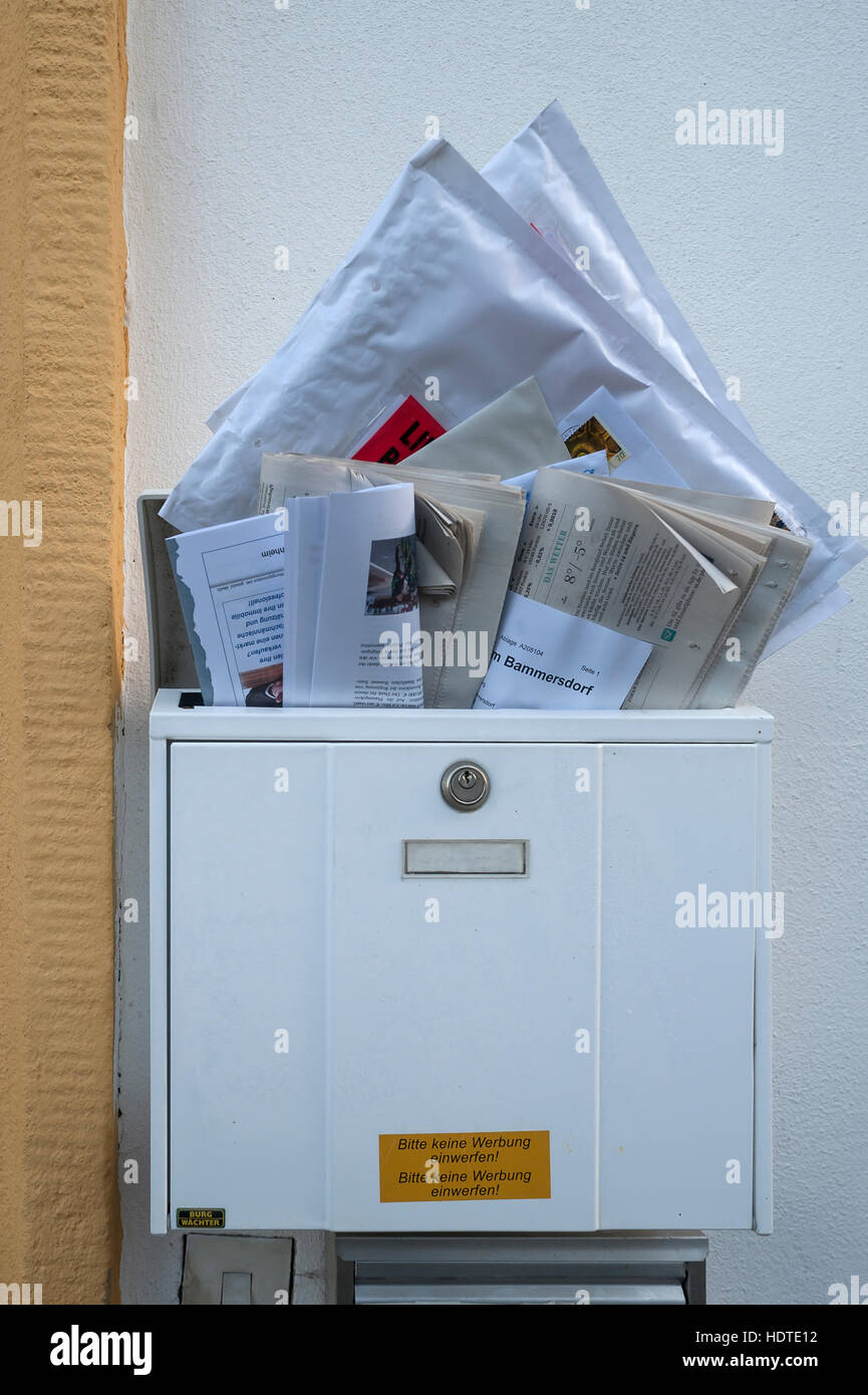 Overfilled mailbox with letters and newspapers, Bavaria, Germany Stock