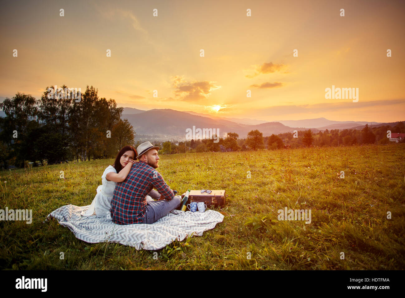 couple in love on white plaid. background mountains sunset Stock Photo