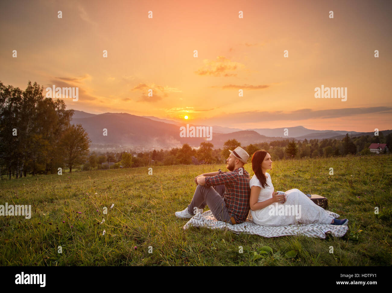 couple in love on white plaid. background mountains sunset Stock Photo