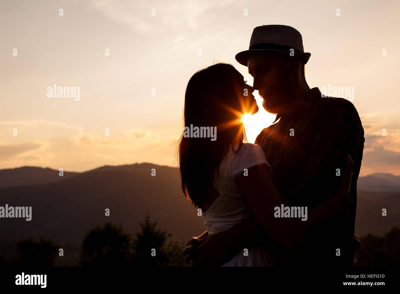 Love story. silhouettes of Couple on the sunset Stock Photo