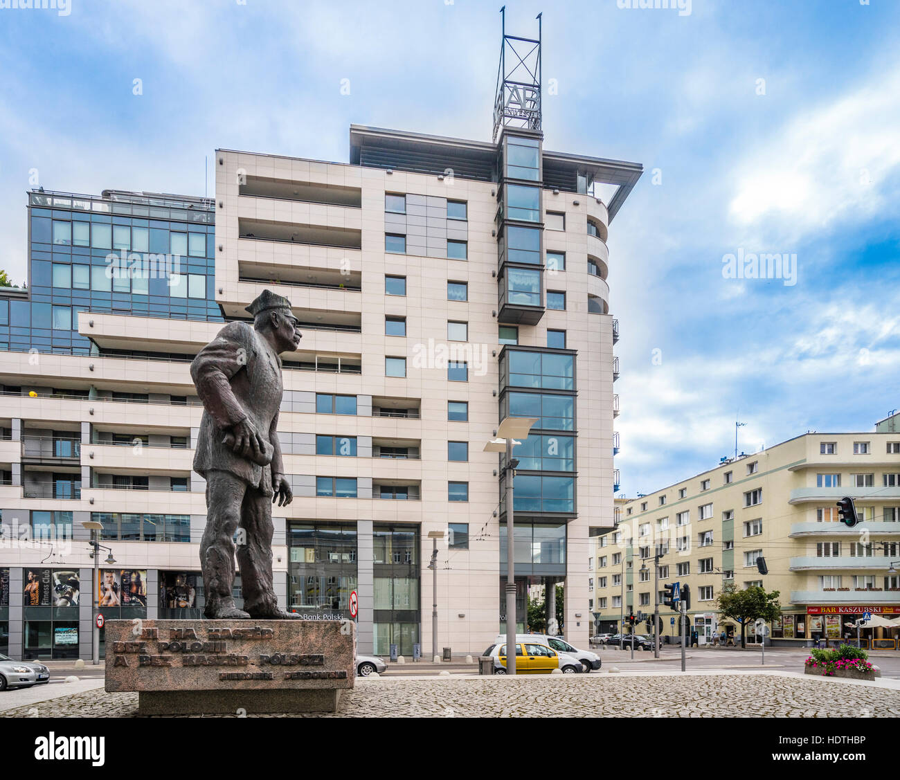 Poland, Pomerania, Gdynia, monument to the Kashubian activist Anthony Abraham and the modern Transatlantik apartment building at Kaszubski Square Stock Photo