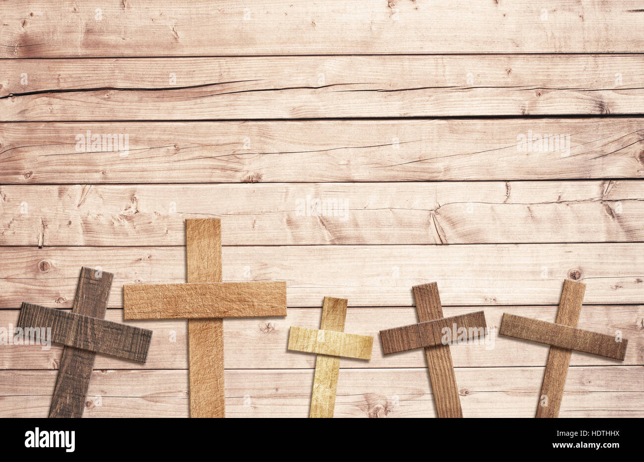 Wooden cross on brown old tabletop or wall surface Stock Photo
