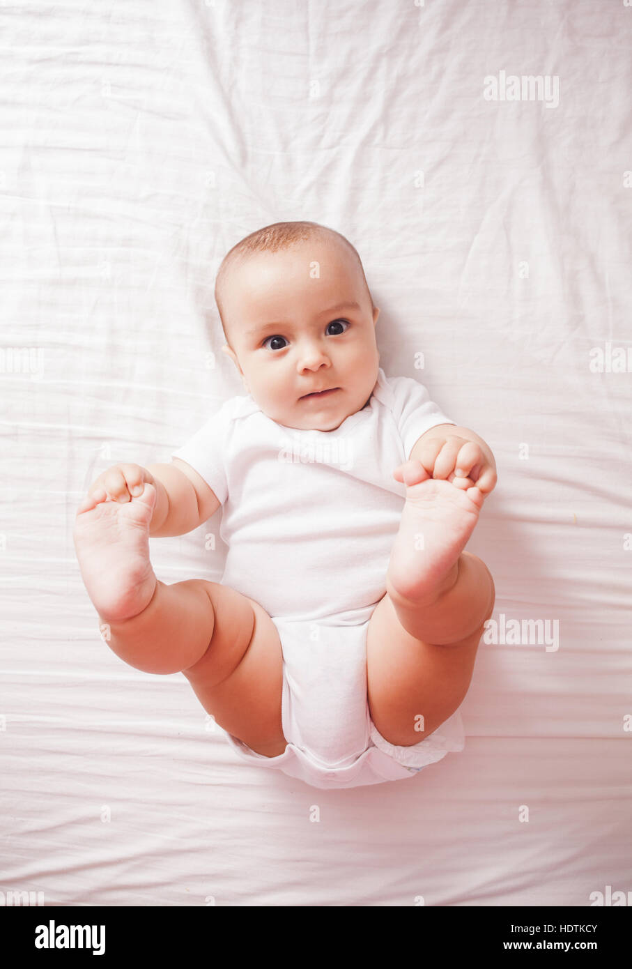 Portrait of a baby lying on the bed Stock Photo Alamy