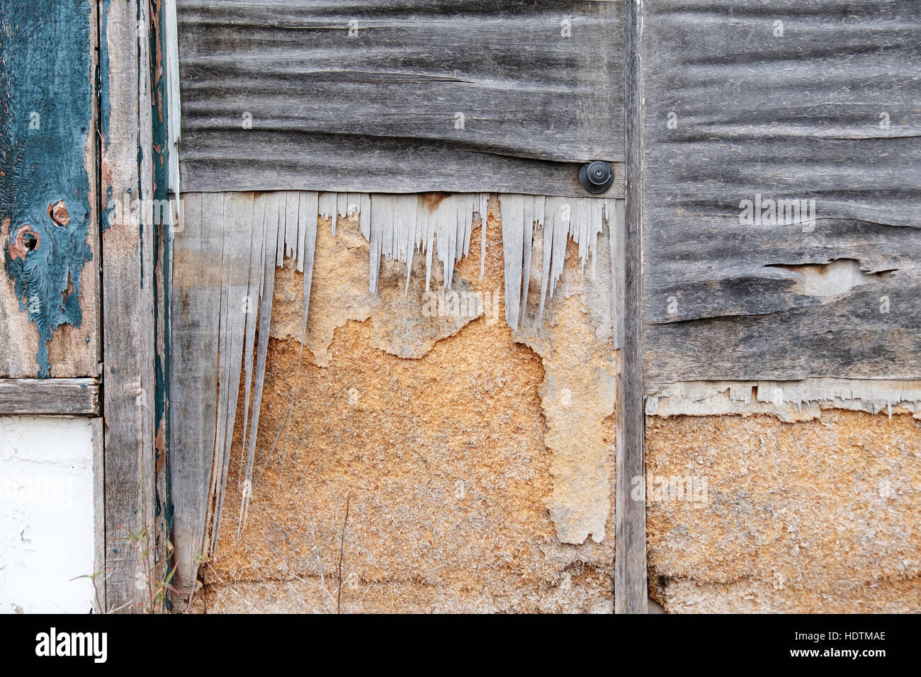 A weathered deteriating exterior door to an abandoned building. USA. Stock Photo