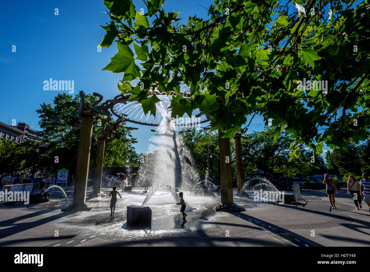 Children playing in a fountain at the Spokane Riverfront development in downtown Spokane WA Stock Photo