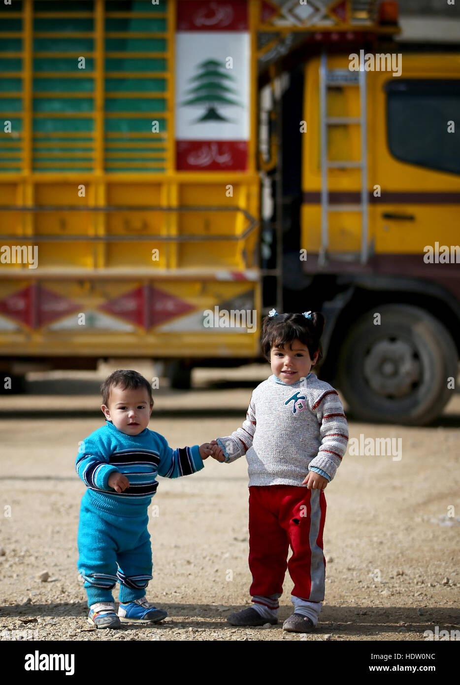 Syrian refugee children, after visiting the doctor, in a refugee camp near Taalabaya in the Bekaa Valley. Stock Photo