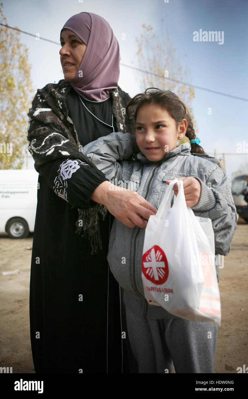 A Syrian refugee woman and her daughter with their medicine after visiting the Caritas mobile medical clinic in their refugee camp near Taalabaya in the Bekaa Valley. Stock Photo