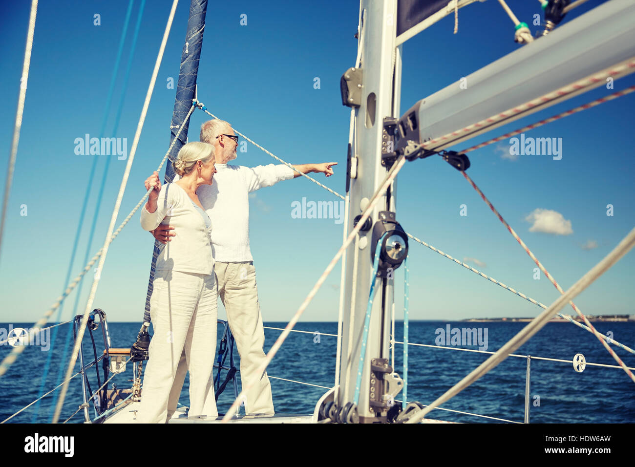 senior couple hugging on sail boat or yacht in sea Stock Photo - Alamy