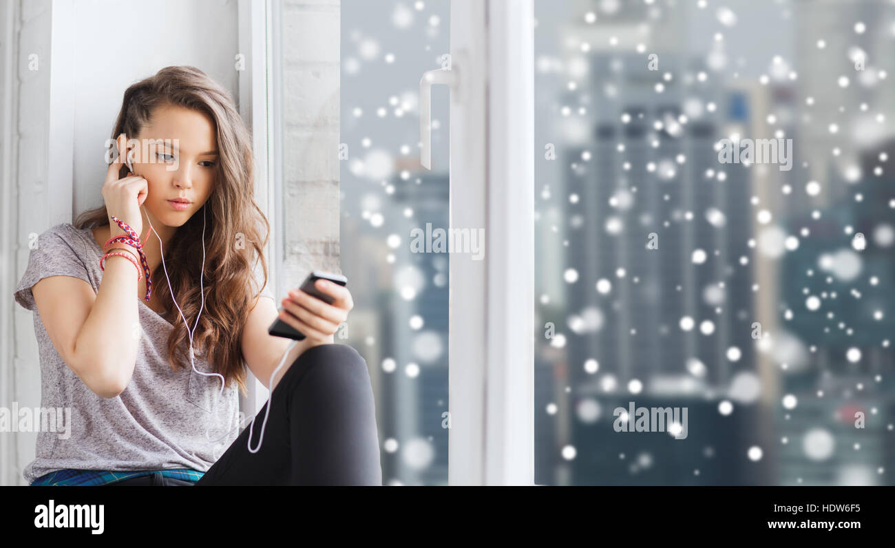 teenage girl with smartphone and earphones Stock Photo - Alamy