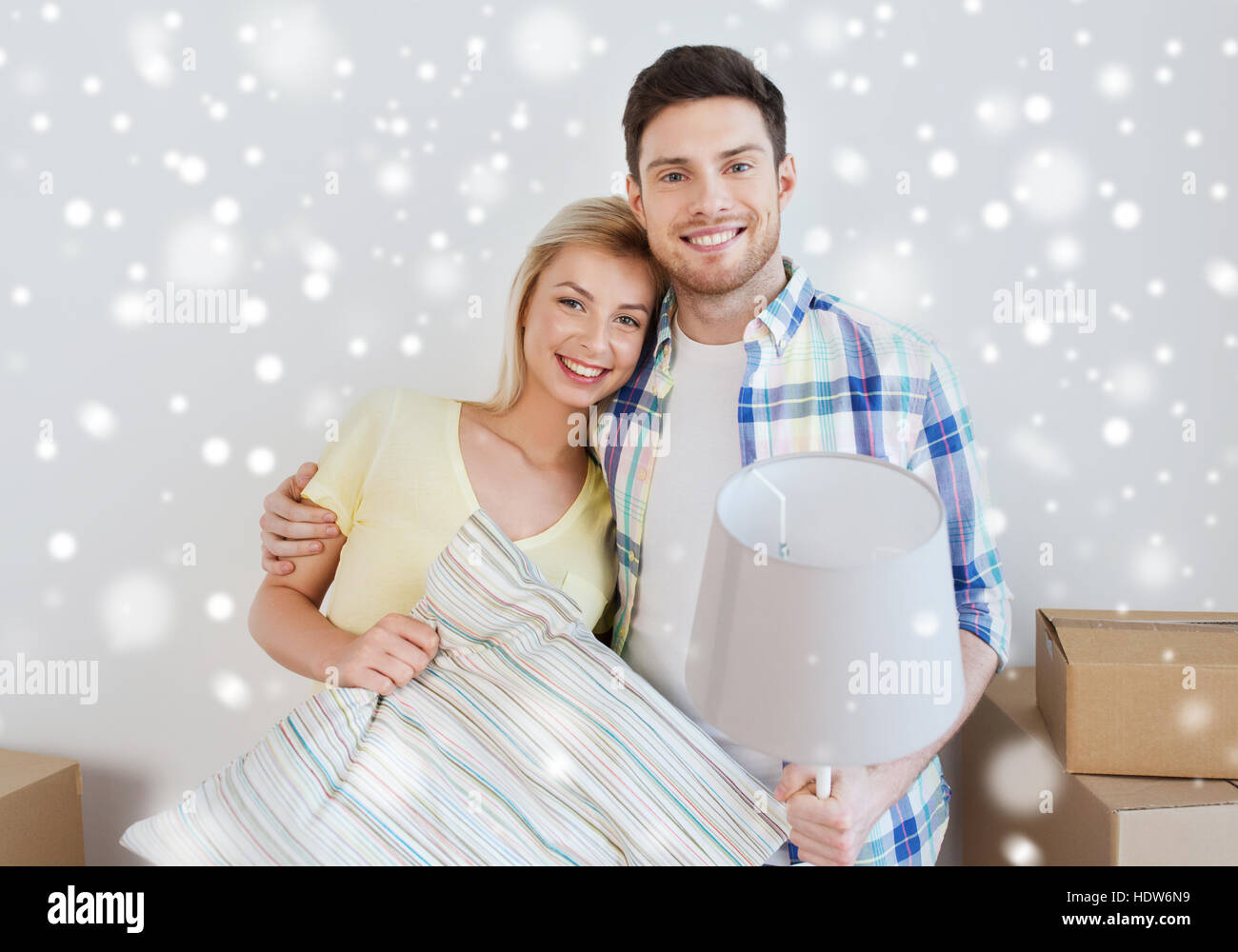 happy couple with stuff moving to new home Stock Photo - Alamy