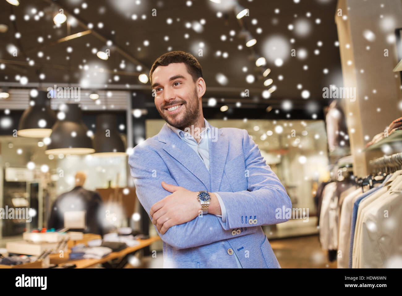 happy young man in jacket at clothing store Stock Photo - Alamy