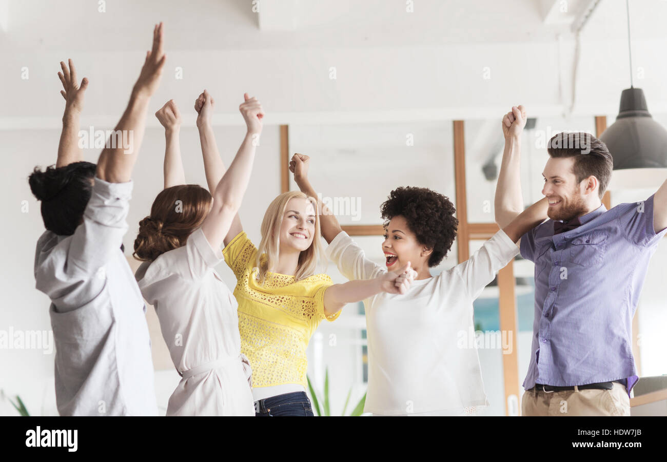 happy creative team celebrating victory in office Stock Photo - Alamy