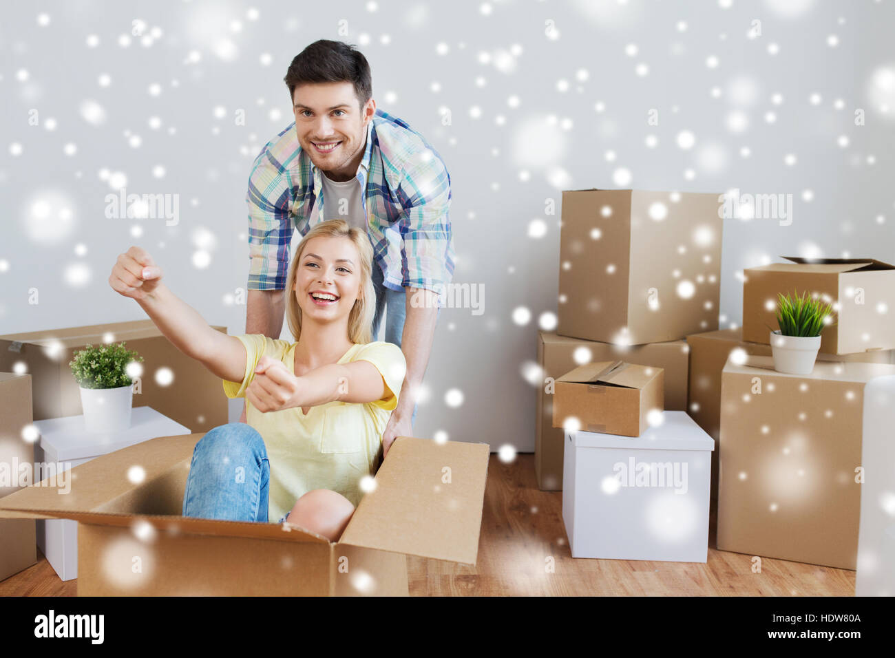 happy couple having fun with boxes at new home Stock Photo - Alamy