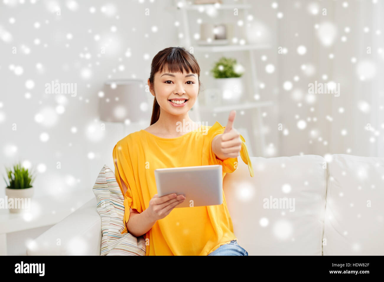 happy asian woman with tablet pc and thumbs up Stock Photo - Alamy