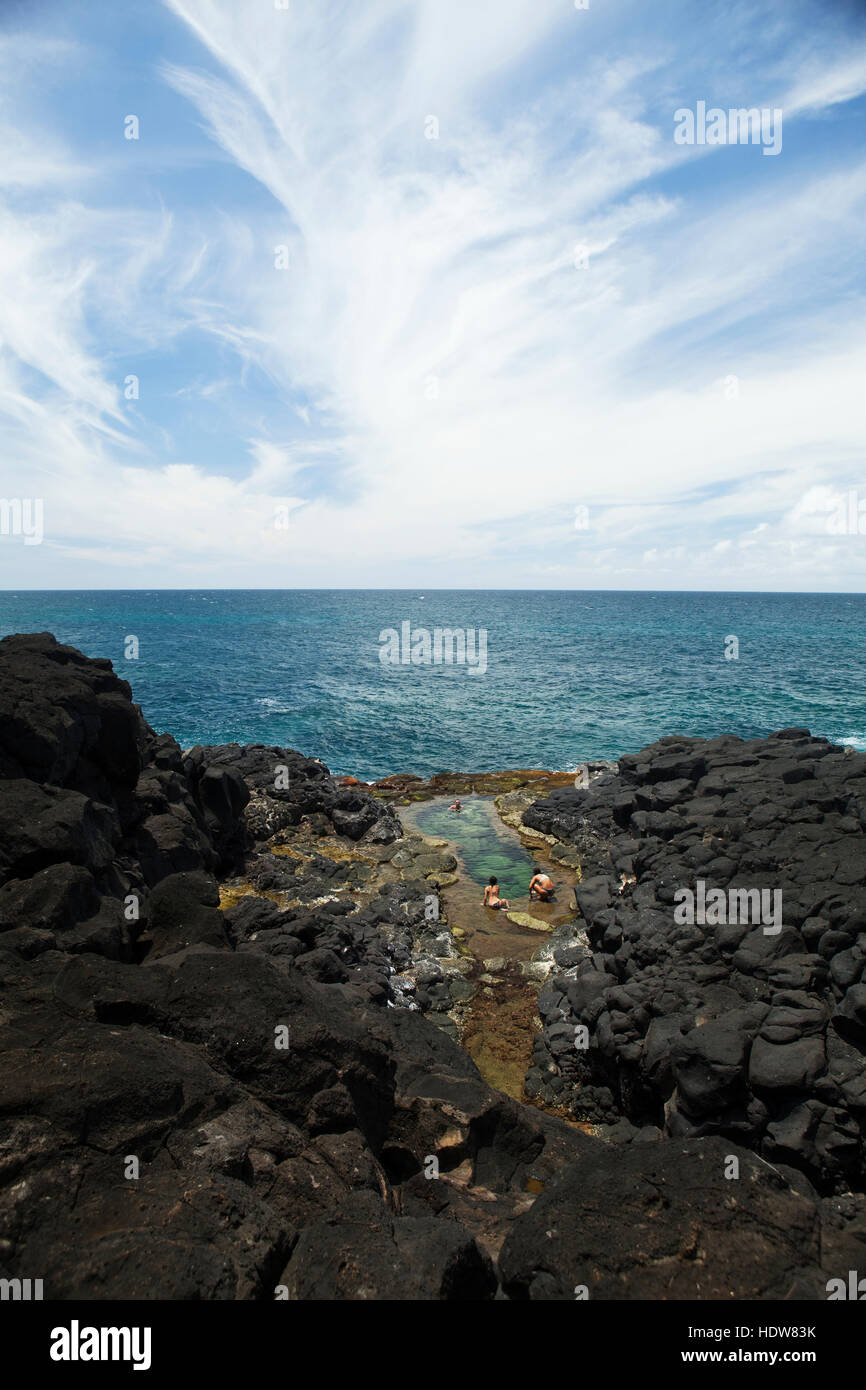 Swimmers in tide pools, Queens Bath; Princeville, Kauai, Hawaii, United