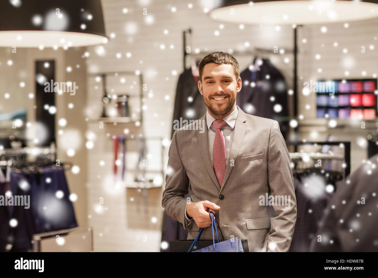 happy man with shopping bags at clothing store Stock Photo - Alamy