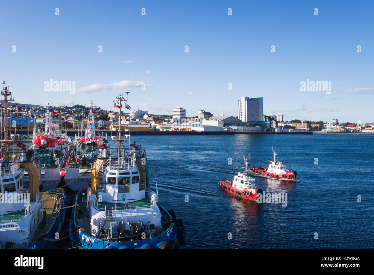 Tugs head out from pier; Punta Arenas, Magallanes and Antartica Chilena, Chile Stock Photo