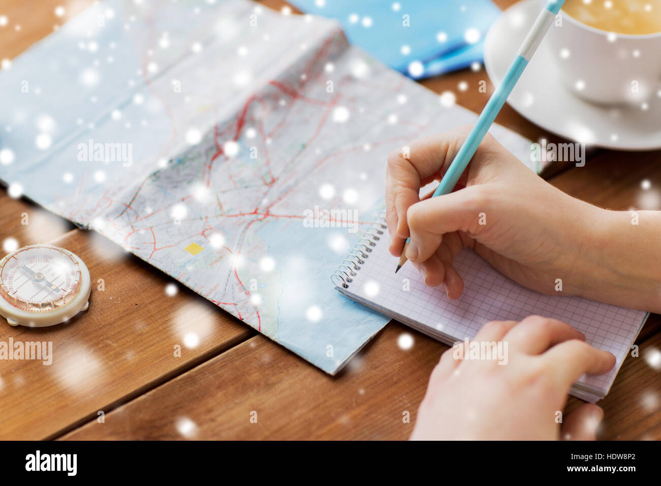 hands with map and compass writing to notebook Stock Photo Alamy