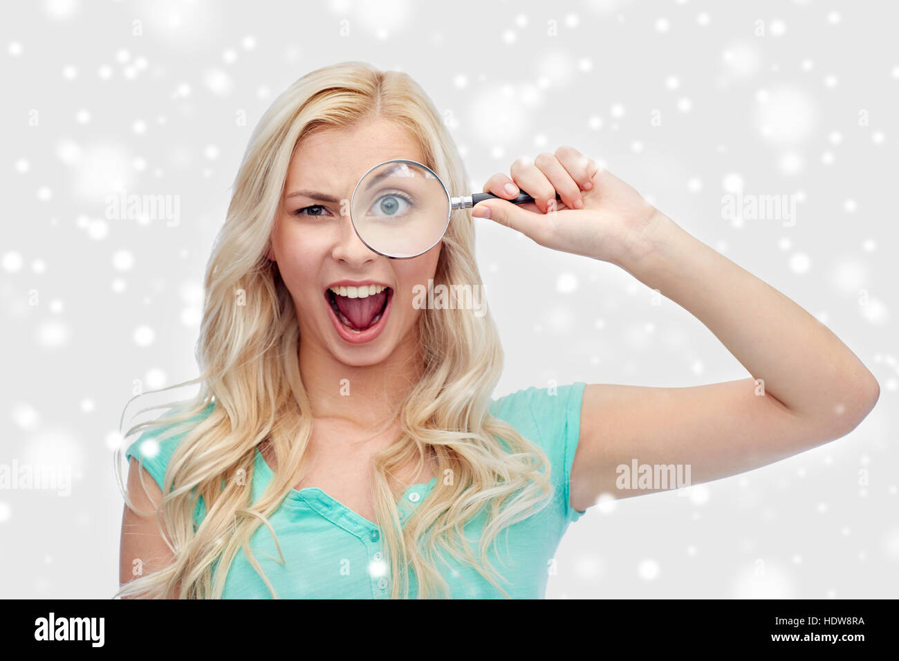 happy young woman with magnifying glass Stock Photo - Alamy