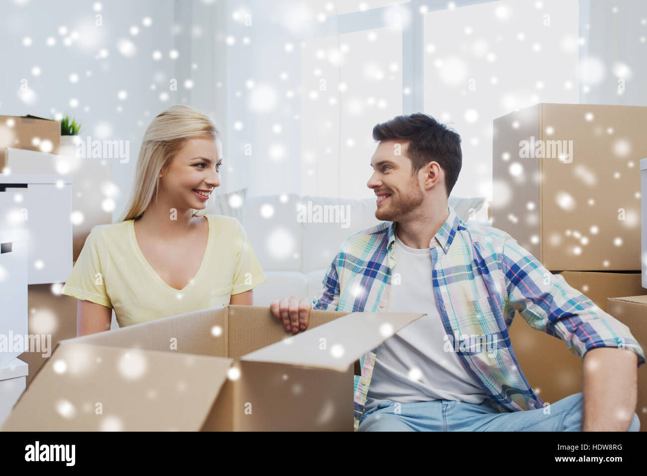 smiling couple with big boxes moving to new home Stock Photo - Alamy