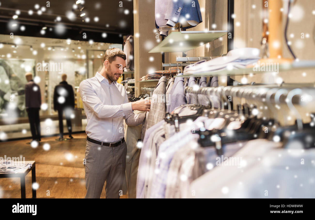 happy young man choosing clothes in clothing store Stock Photo - Alamy