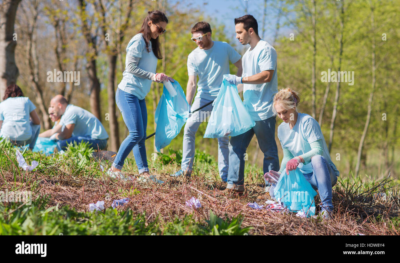 volunteers with garbage bags cleaning park area Stock Photo Alamy