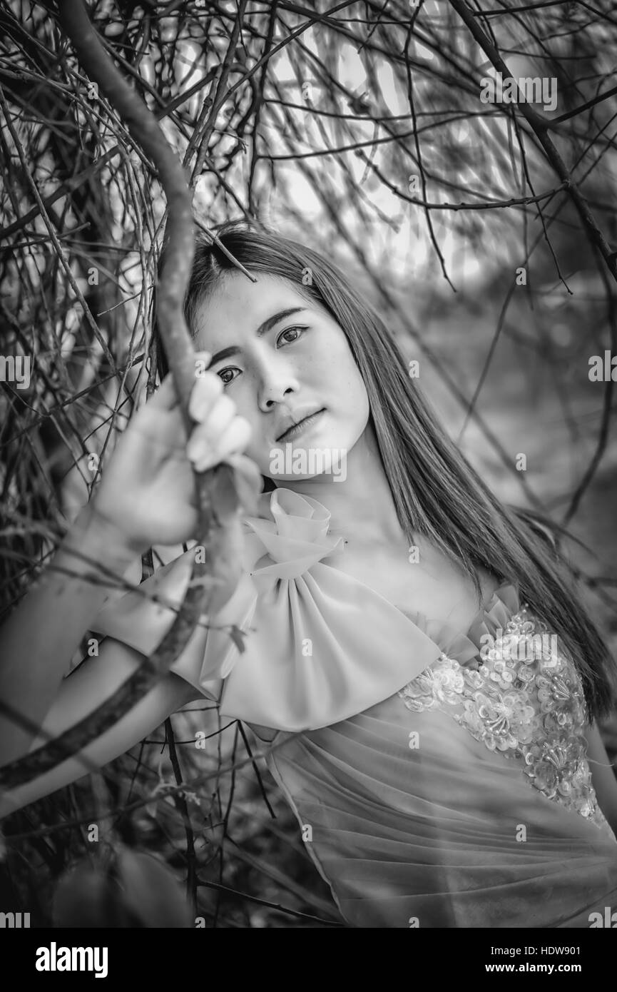 Portrait of Asia Beautiful woman in yellow dress on nature, black and ...