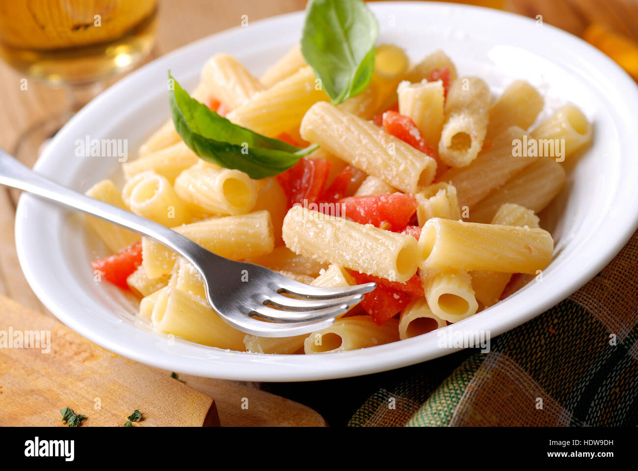 rigatoni pasta with chopped tomatoes and basil Stock Photo Alamy