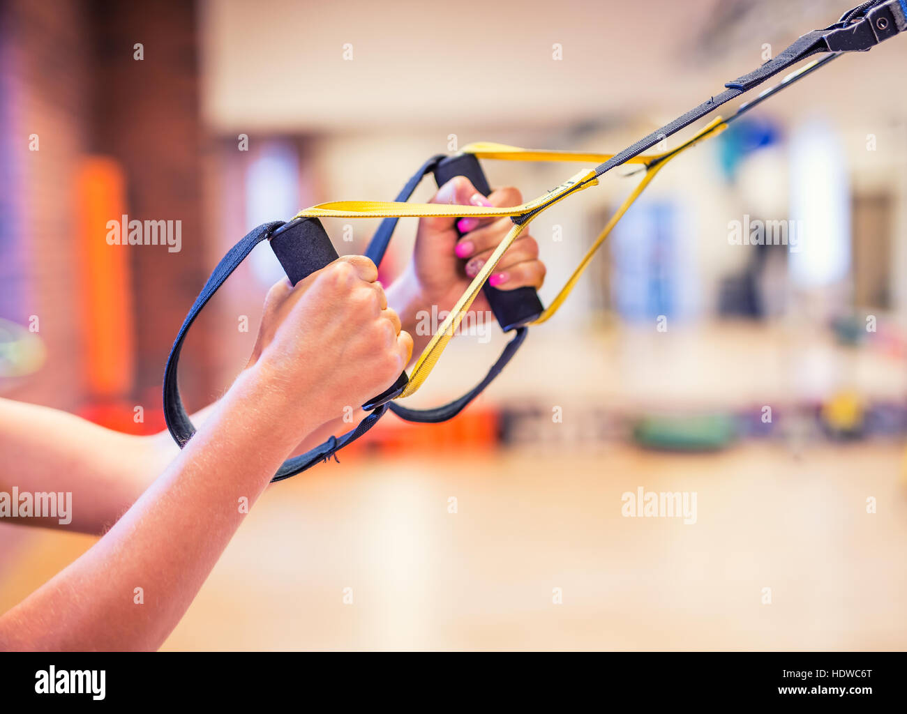 TRX. Female hands with fitness TRX straps in gym Stock Photo Alamy
