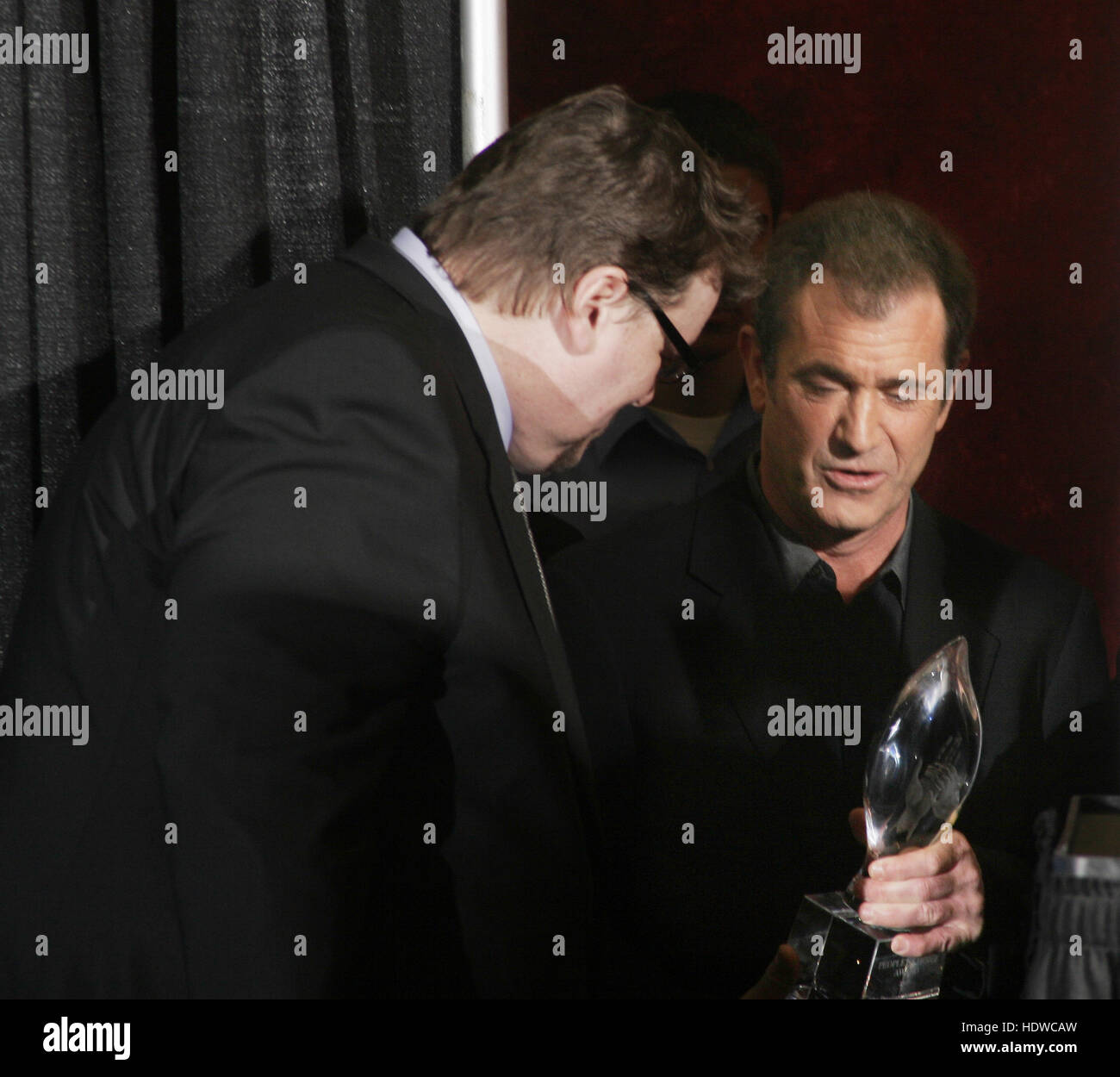 Michael Moore, left, and Mel Gibson meet backstage at the People's Choice Awards in Pasadena, California on Sunday January 9, 2005. Photo credit: Francis Specker Stock Photo