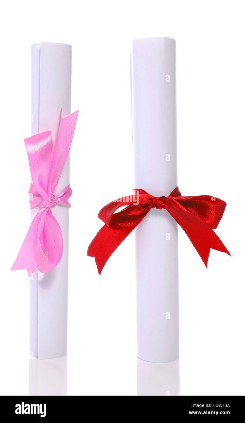 Two graduation diploma scroll tied with ribbon isolated on white background Stock Photo