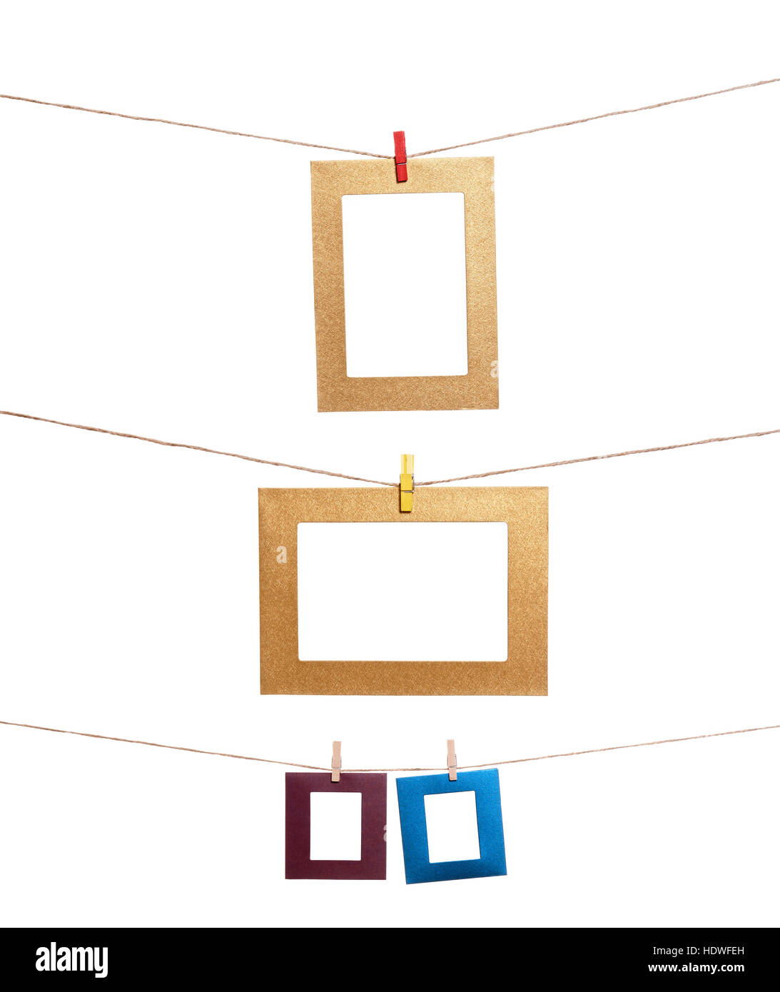 Collection of blank photo frames hanging by clothespins on a rope. You