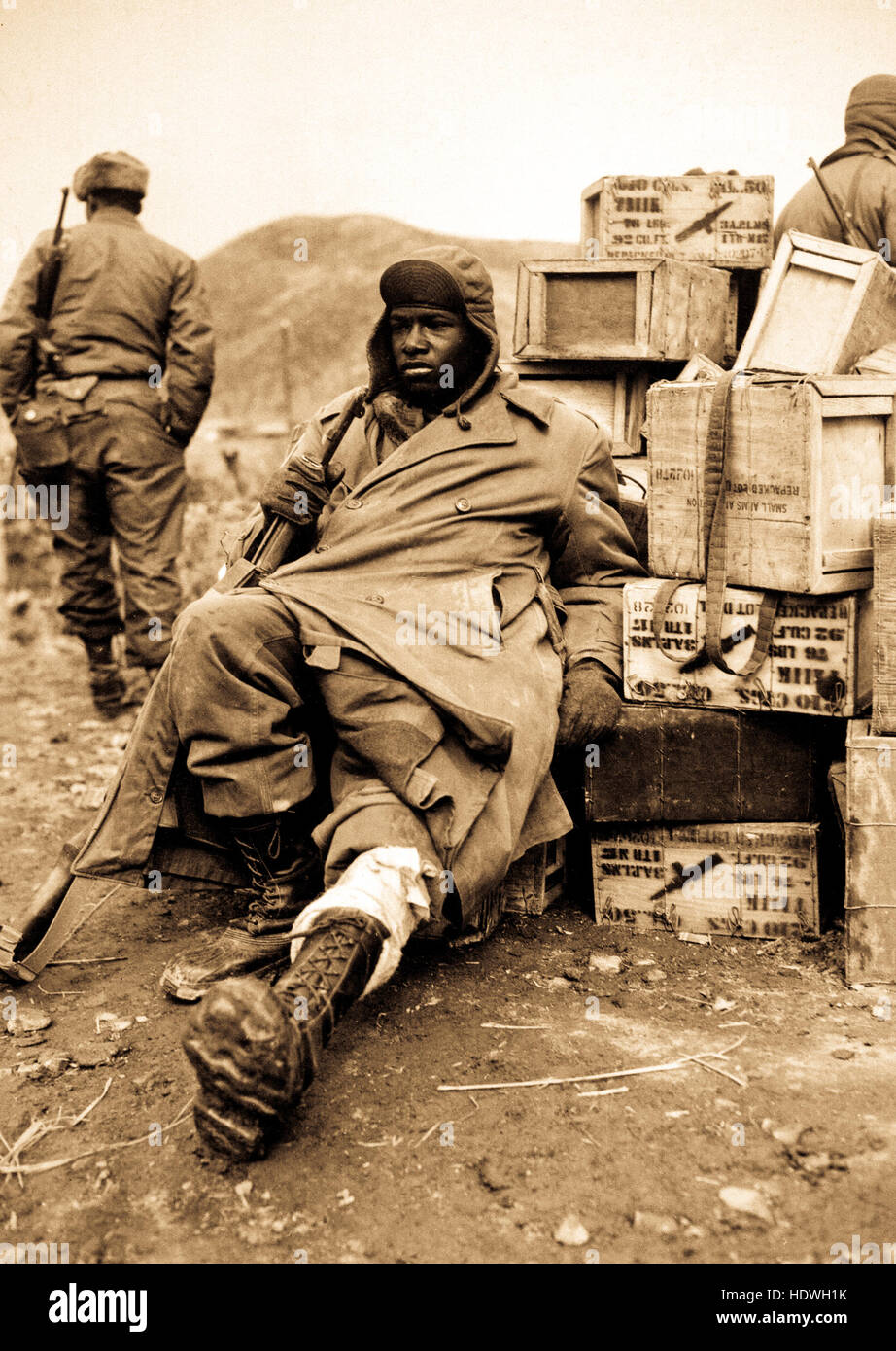 Pfc. Edward Wilson, 24th Infantry Regiment, wounded in leg while engaged in action against the enemy forces near the front lines in Korea, waits to be evacuated to aid station behind the lines.  February 16, 1951. Photo by Pfc. Charles Fabiszak. Stock Photo